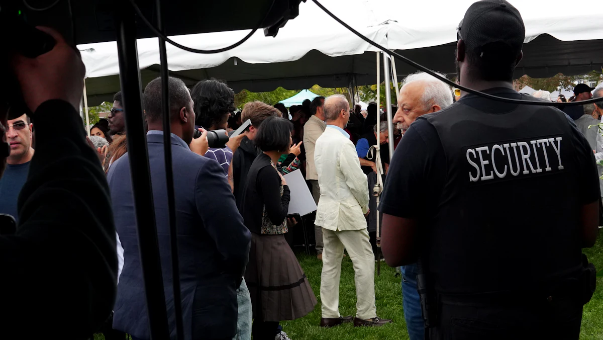 A security officer watching over a crowd at an event