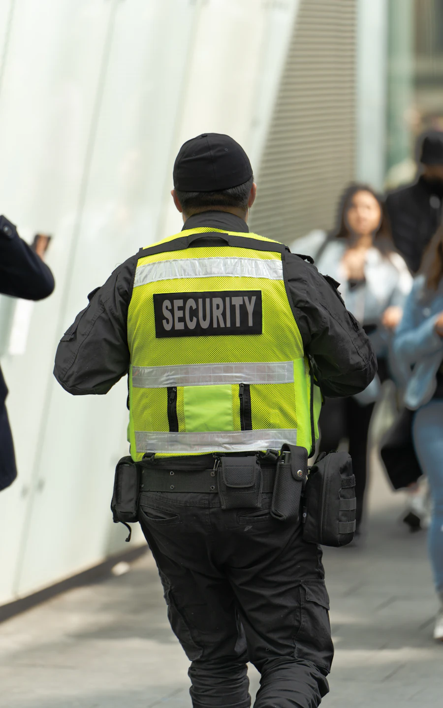 A security officer in a hi-vis vest on patrol
