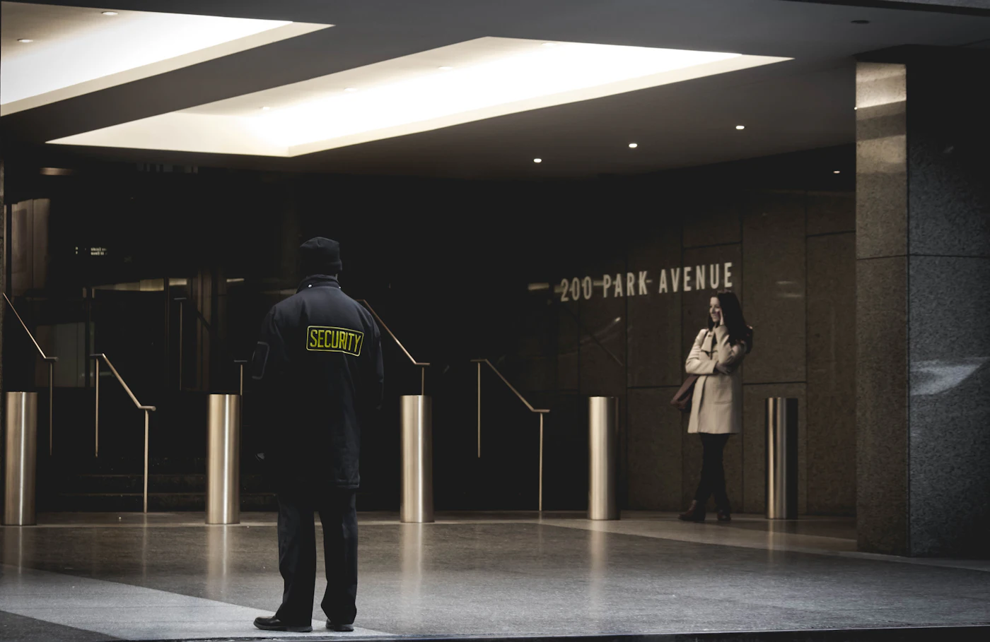 A security officer standing in a building lobby